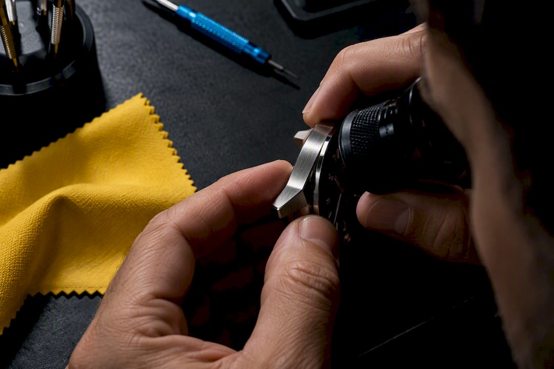 Founder inspecting an anonymous watch case
