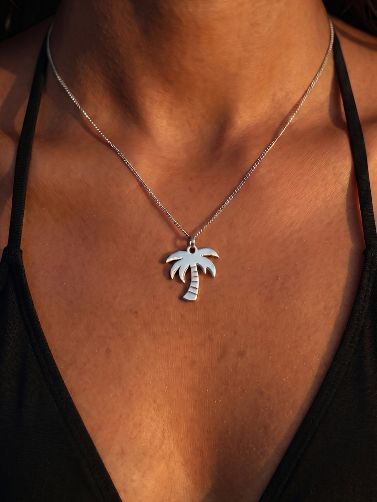 Woman wearing the WYNWOOD BLVD Silver Palm Tree Pendant necklace inspired by Miami's tropical lifestyle