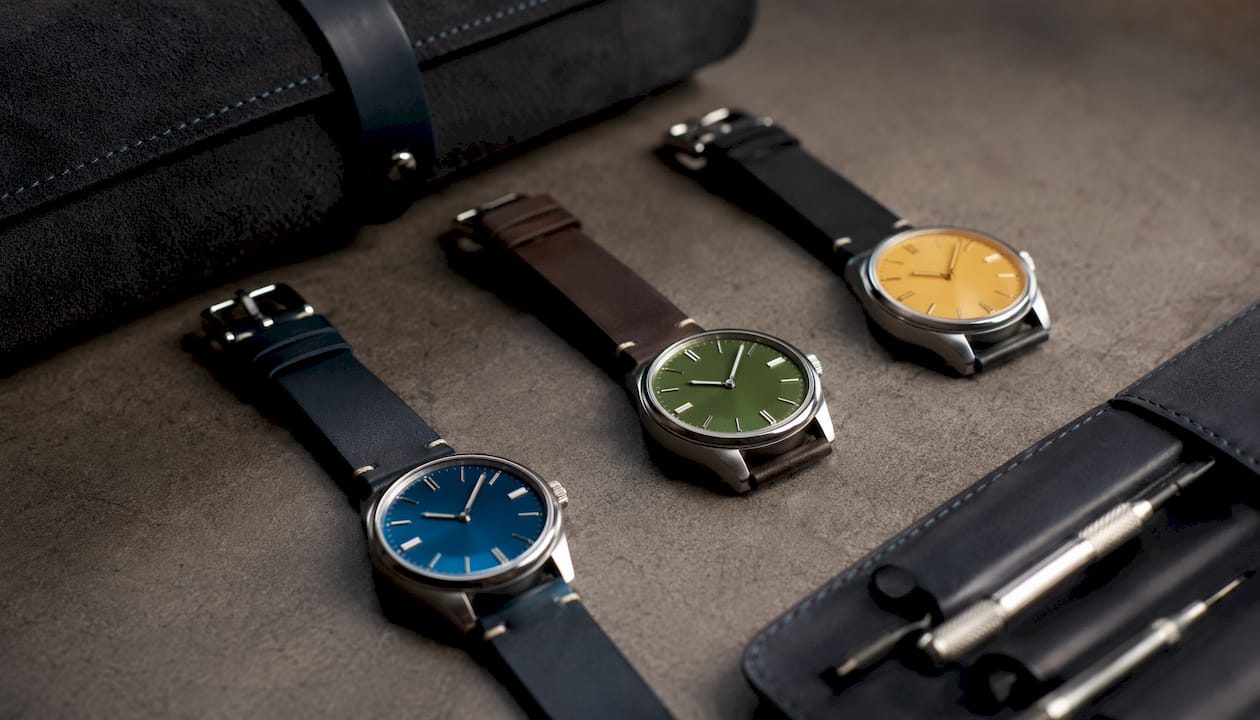 Three minimalist automatic watches on white surface
