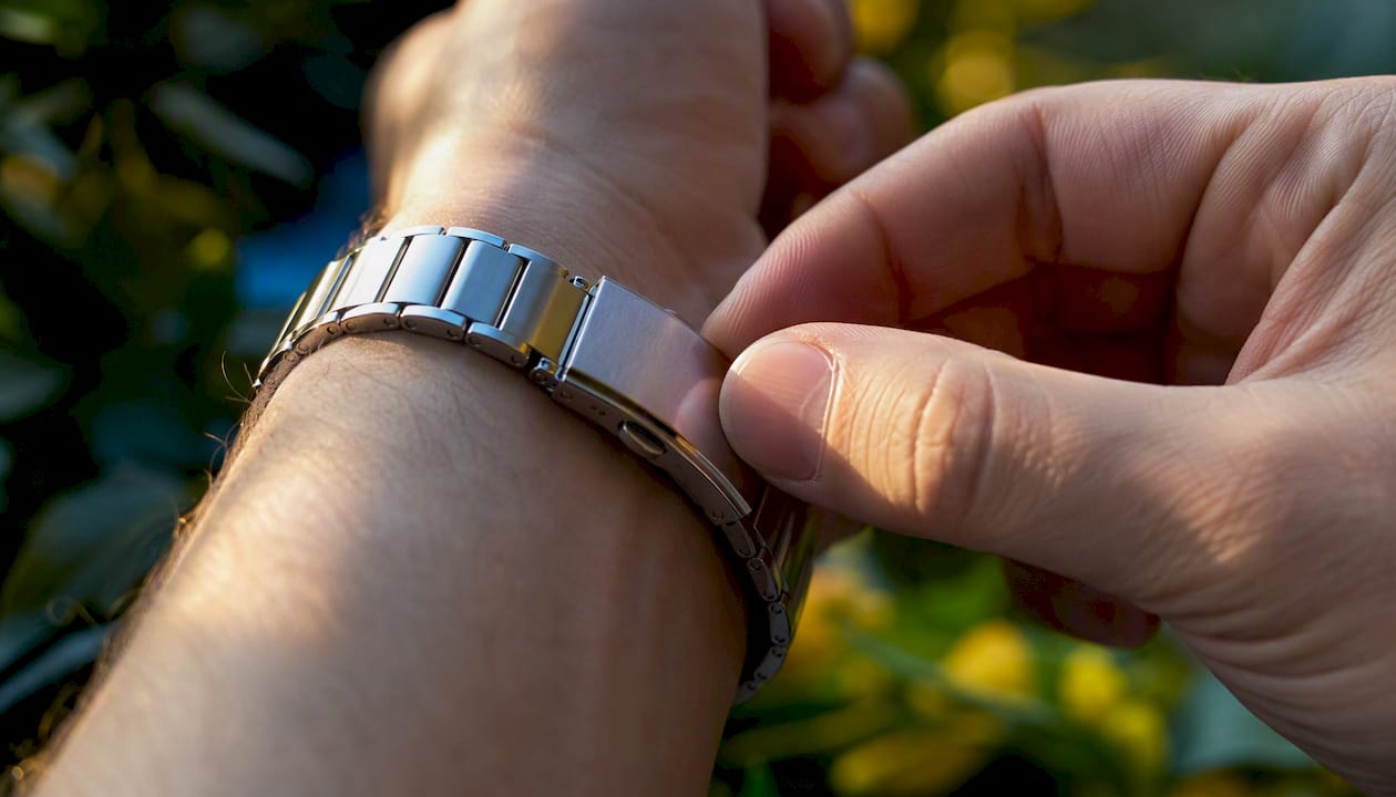 Close-up of stainless steel watch clasp outdoors