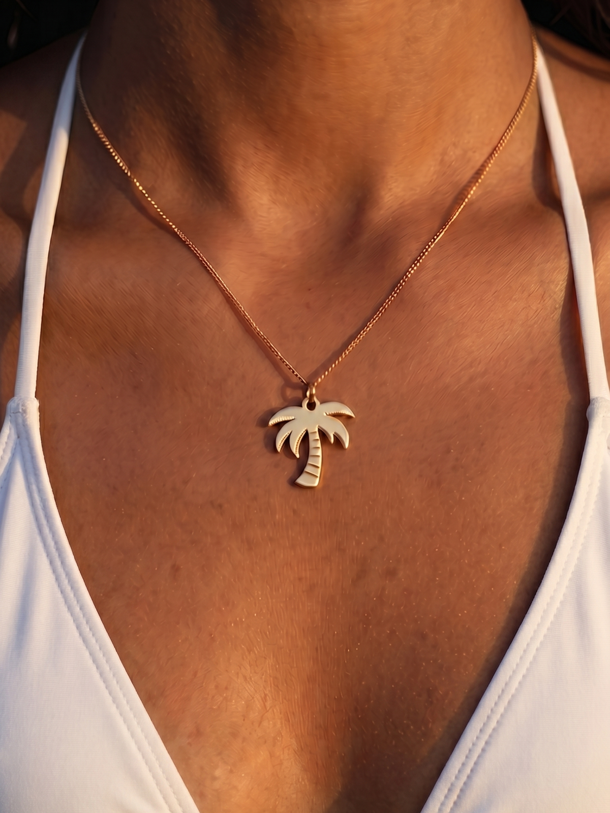 Woman wearing the WYNWOOD BLVD Gold Classic Palm Tree Pendant necklace.