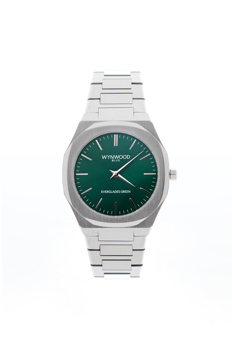 Front view of the WYNWOOD BLVD Everglades Green watch featuring a stainless steel bracelet and deep green dial on a clean white background.