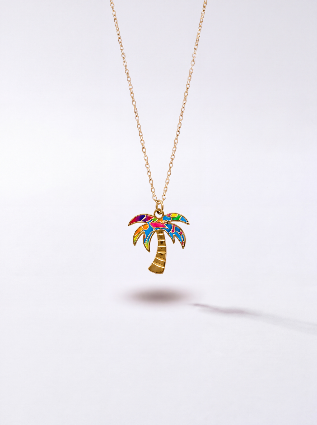 Gold Graffiti palm tree pendant necklace with multicolor enamel by WYNWOOD BLVD on a clean white background.