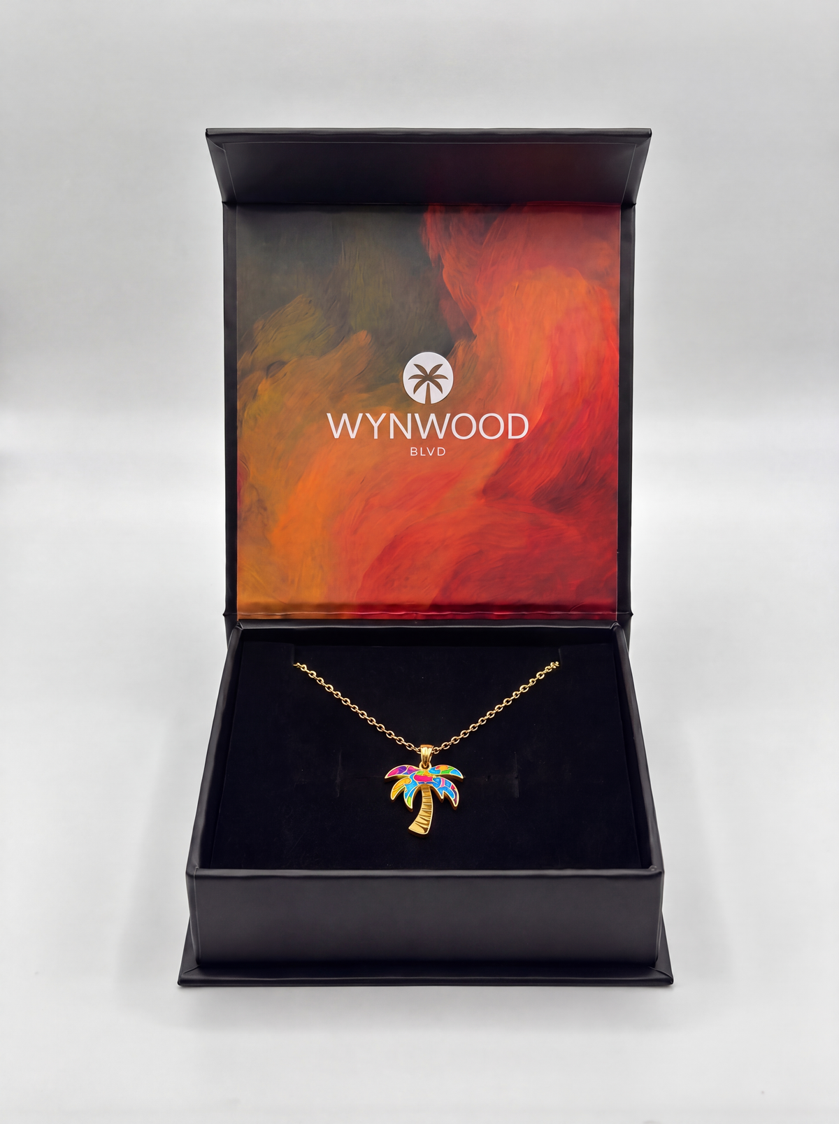 Open WYNWOOD BLVD jewelry gift box featuring the Gold Graffiti Palm Tree Pendant necklace in premium packaging.
