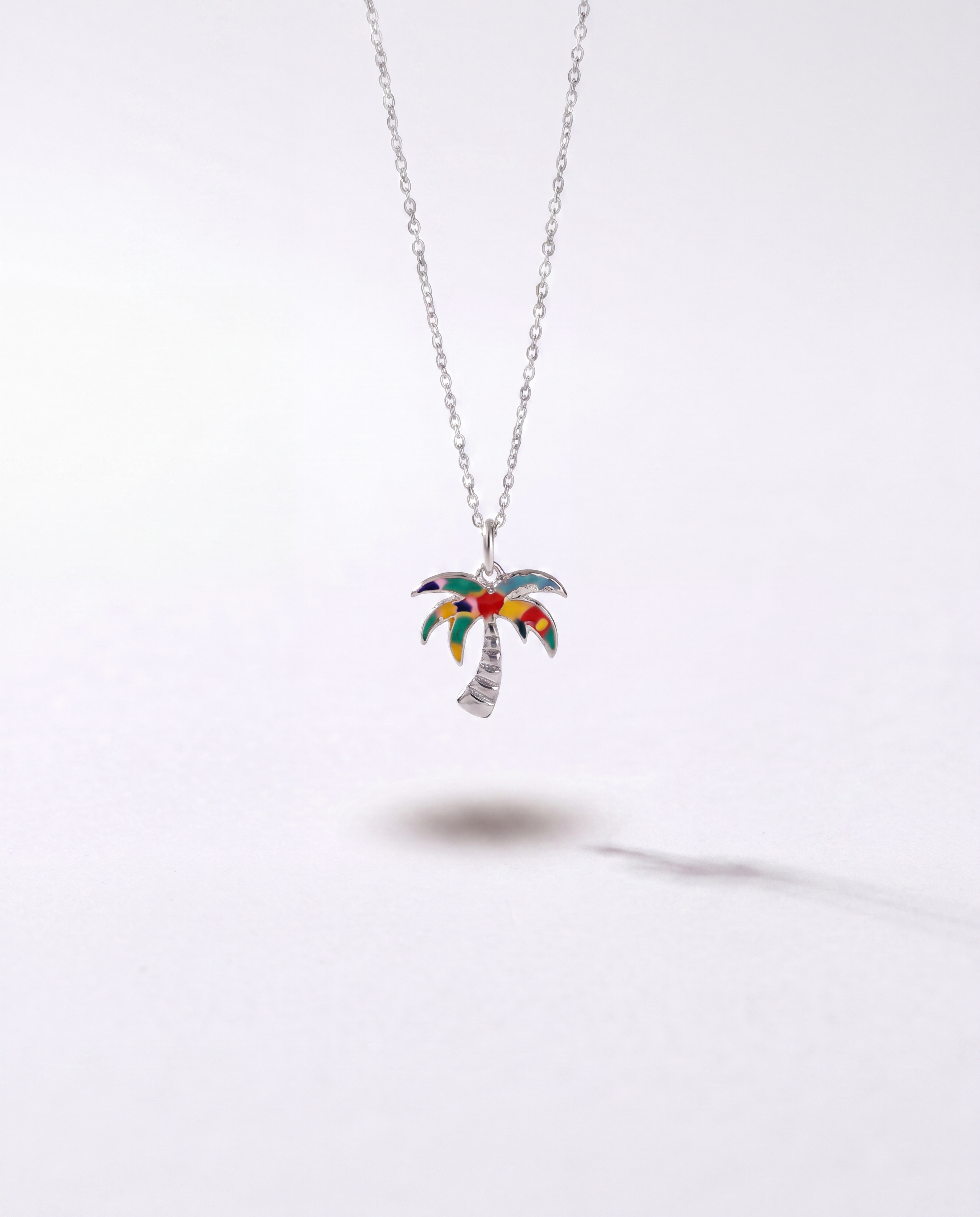 Silver palm tree pendant necklace by WYNWOOD BLVD on a clean white background.