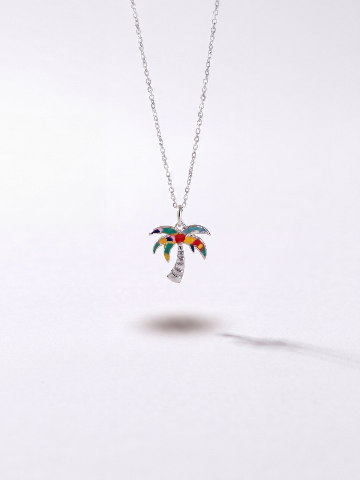 Silver palm tree pendant necklace by WYNWOOD BLVD on a clean white background.