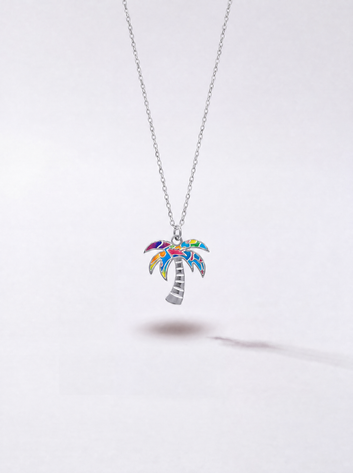 Silver Graffiti palm tree pendant necklace with multicolor enamel by WYNWOOD BLVD on a clean white background.