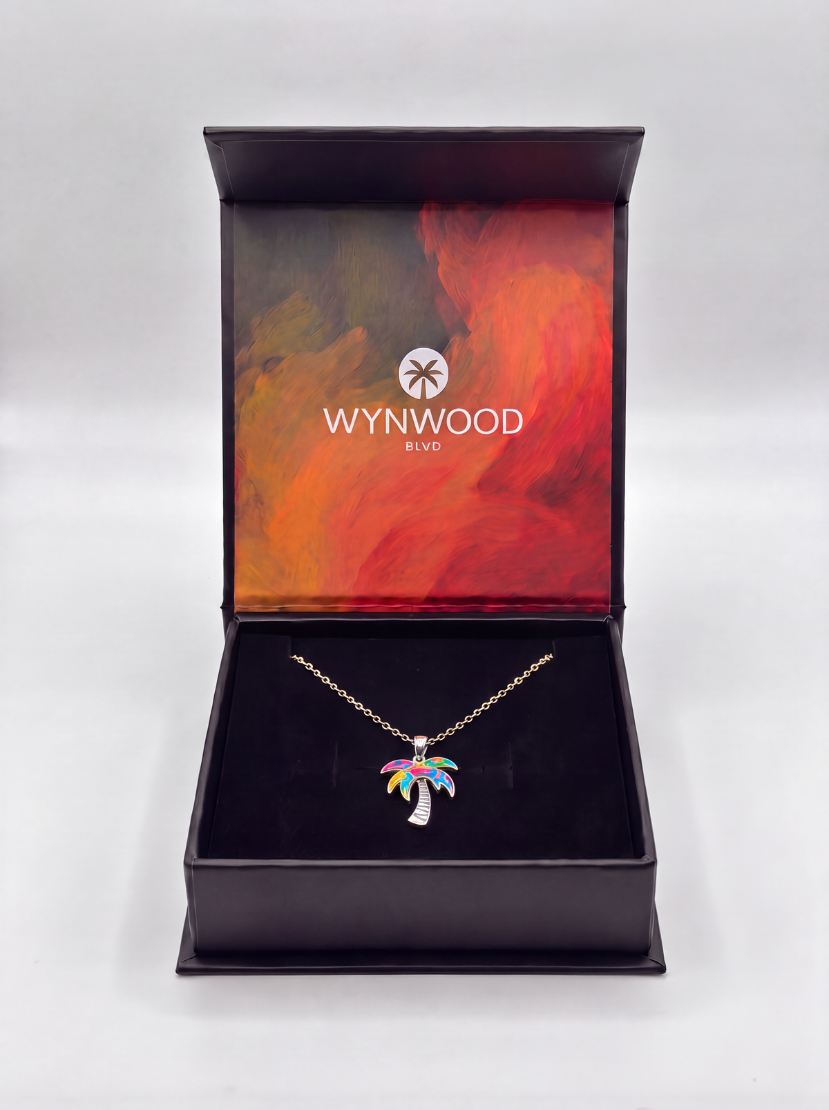 Open WYNWOOD BLVD jewelry gift box featuring the Silver Graffiti Palm Tree Pendant necklace in premium packaging.