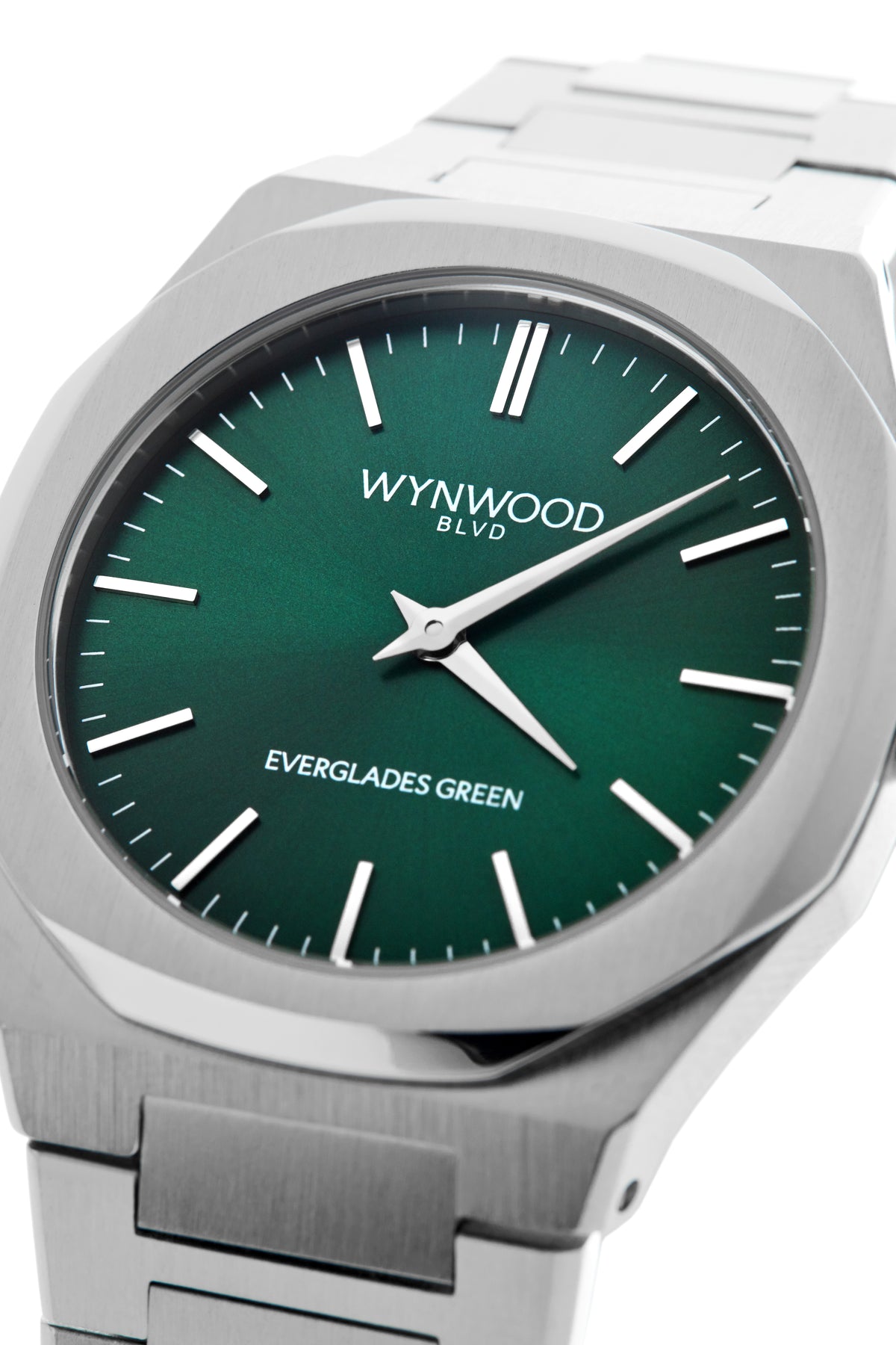 Three-quarter close-up of the WYNWOOD BLVD Everglades Green watch featuring a brushed stainless steel case and deep green dial.